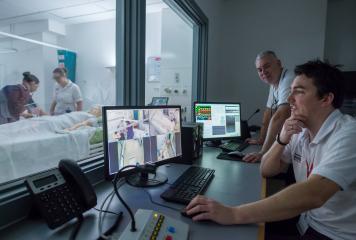 Student and supervisor in simulation suite control room